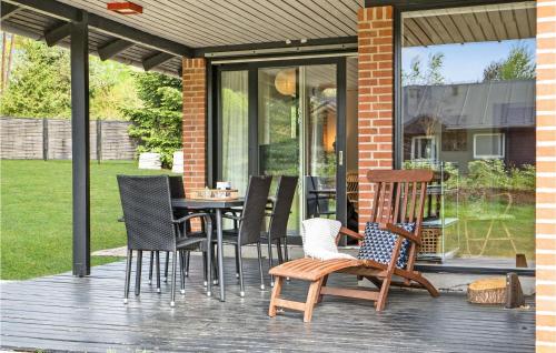 a patio with chairs and a table on a deck at Two-Bedroom Holiday Home In Knebel in Knebel