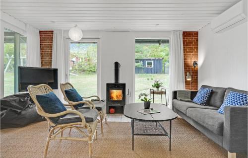 a living room with a couch and a fireplace at Two-Bedroom Holiday Home In Knebel in Knebel