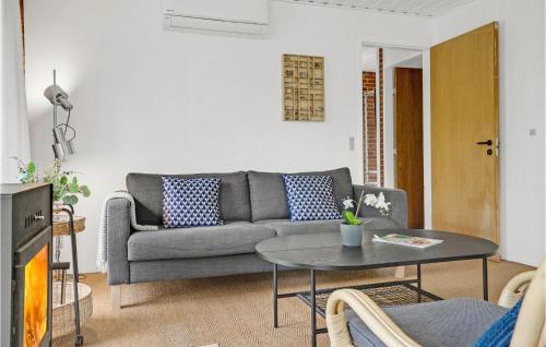 a living room with a couch and a table at Two-Bedroom Holiday Home In Knebel in Knebel