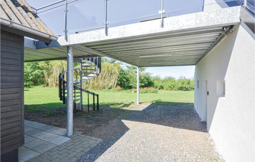 a building with awning and a staircase in a yard at Three-Bedroom Holiday Home In Vinderup in Vinderup