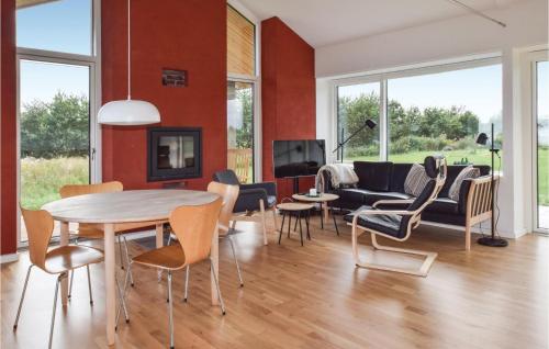 a living room with a table and chairs at Two-Bedroom Holiday Home In Tranekar in Tranekær