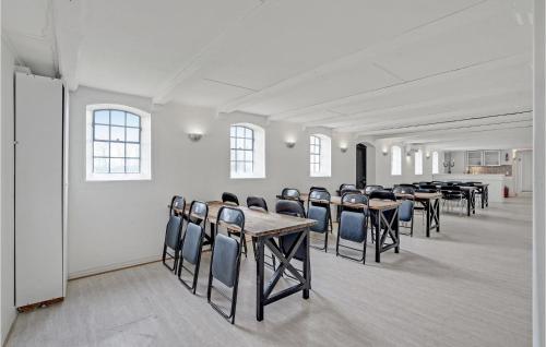 a group of tables and chairs in a room at Amazing Home In Søllested With Wifi in Søllested