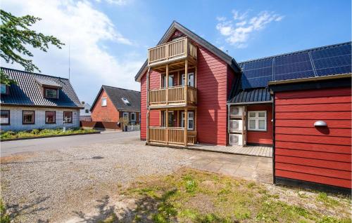 a red house with a red garage at Three-Bedroom Apartment In Bagenkop in Bagenkop