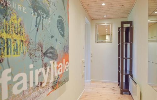 a hallway with a large painting on the wall at Three-Bedroom Apartment In Bagenkop in Bagenkop