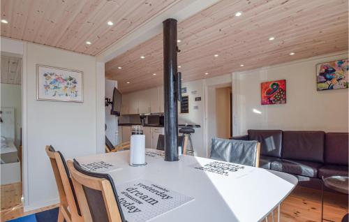 a kitchen and dining room with a white table and chairs at Three-Bedroom Apartment In Bagenkop in Bagenkop