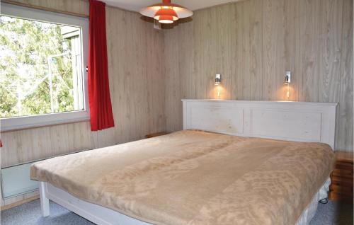a bedroom with a large bed and a window at 3 Bedroom Nice Home In Kirke Hyllinge in Kirke-Hyllinge