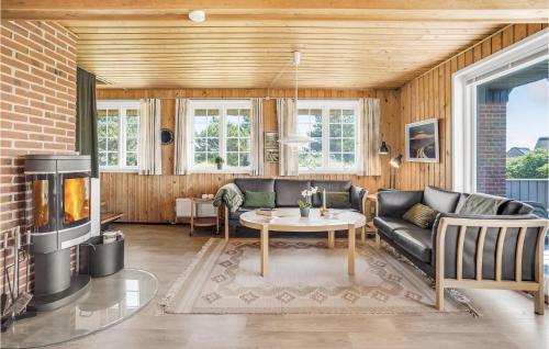 a living room with a couch and a fireplace at Holiday Home Sønderho Strandvej Fanø in Sønderho