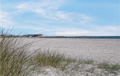 a beach with sand and the ocean in the background at Cozy Home In Grenaa With House Sea View in Grenå