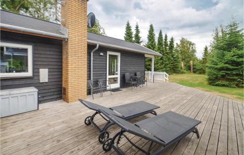 a deck with a picnic table on a house at Holiday Home Gråpilevej in Bøtø By