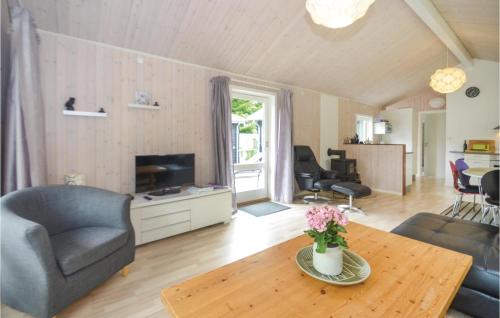 a living room with a couch and a table at Holiday Home Gråpilevej in Bøtø By