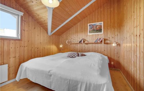a bedroom with a bed in a wooden wall at Awesome Home In Hvide Sande With Kitchen in Hvide Sande
