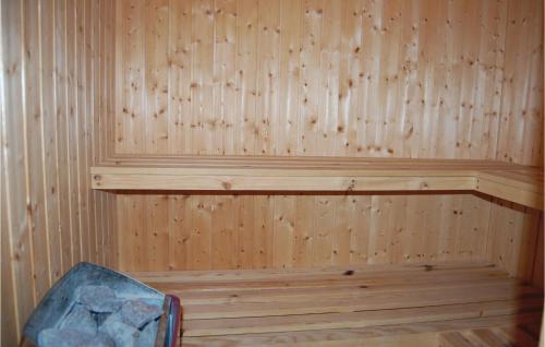 a wooden paneled sauna with a bench in it at Holiday Home Falkevej Idestrup X in Bøtø By