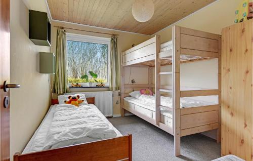 a bedroom with two bunk beds and a window at Amazing Home In Sydals With 2 Bedrooms And Wifi in Skovby
