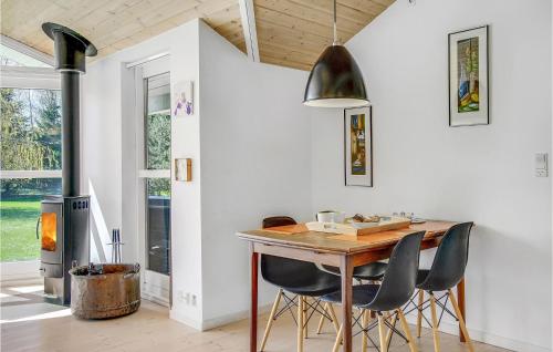 a dining room with a table and chairs and a wood stove at Beautiful Home In Kalundborg With Wifi in Kalundborg