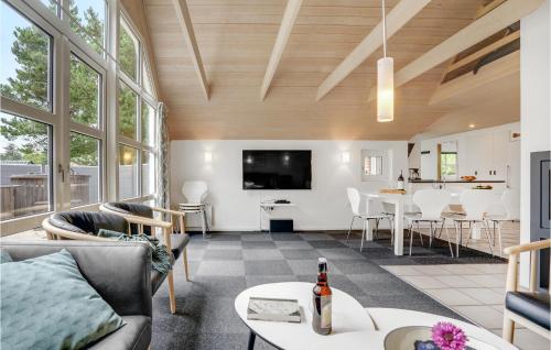 a living room with a couch and a table at Four-Bedroom Holiday Home In Norre Nebel in Nørre Nebel