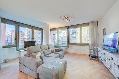 uma sala de estar com um sofá e uma televisão de ecrã plano em Dandy House Few Min From Lake - Happy Rentals em Lugano