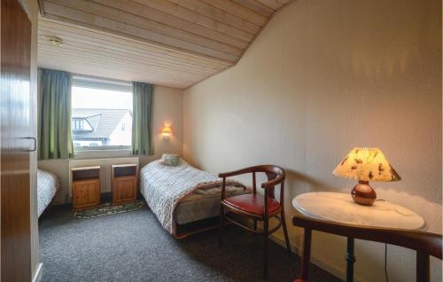 a bedroom with a bed and a table with a lamp at Foldingbro Kro in Lintrup