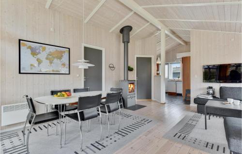 a dining room and living room with a table and chairs at Holiday Home Pøt Strandby Ii Juelsminde I in Sønderby