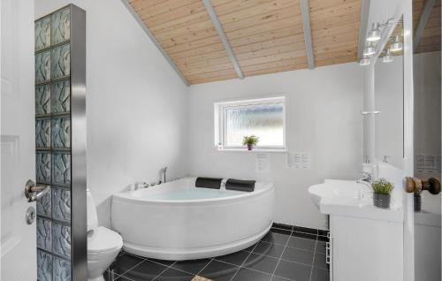 Spodsbjergにある4 Bedroom Lovely Home In Rudkbingの白いバスルーム(バスタブ、トイレ付)