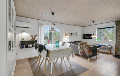 a living room with a table and a couch at Holiday Home Søgårdsvej Ansager in Ansager