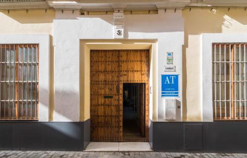a door leading to a small room with a blue door at La Casa del Conde de Gelves Apartments in Seville