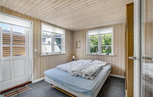 a bedroom with a bed in a room with two windows at Bedste Bo in Sønder Bjert