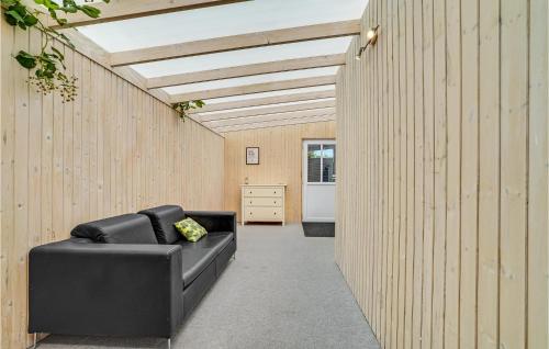 a black leather couch sitting in a hallway at Cozy Home In Farsø With Sauna in Farsø