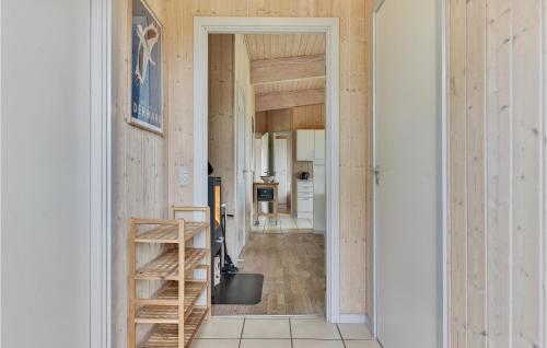 a hallway with wood paneling and a staircase in a house at Nice Home In Faaborg With Kitchen in Faaborg