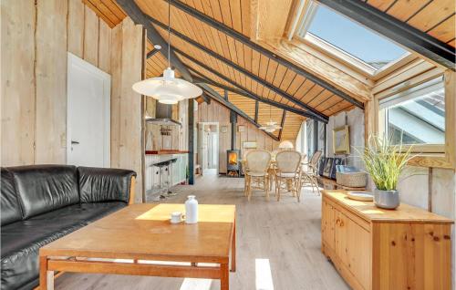 a living room with a couch and a table at Holiday Home Romo Lxix in Bolilmark