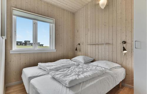 a bed in a room with a window at Nice Home In Faaborg With Kitchen in Fåborg