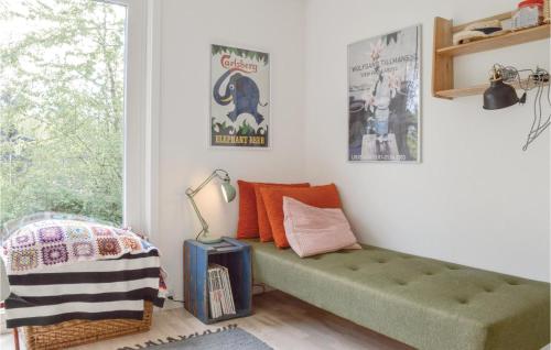 a room with a green bench and posters on the wall at Awesome Home In lsted With 3 Bedrooms And Wifi in Ølsted