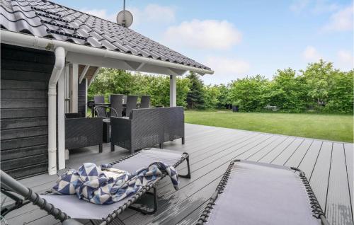 a deck with a gazebo and chairs on it at Holiday Home Vestertoften in Høruphav