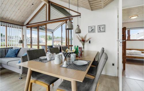 a dining table and chairs in a living room at Holiday Home Vinkelbæk Dnmkt in Nordborg