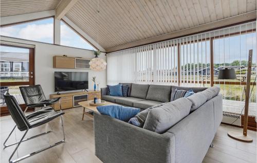 a living room with a couch and a television at Holiday Home Vinkelbæk Dnmkt in Nordborg