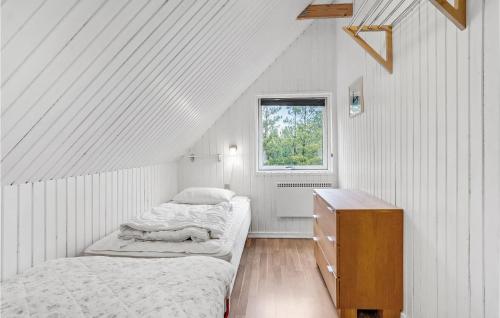 two beds in a white room with a window at Holiday Home Koubjerg Iii in Toftum