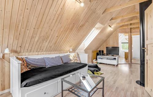a bedroom with a bed in a room with wooden ceilings at Holiday Home Koubjerg Iii in Toftum
