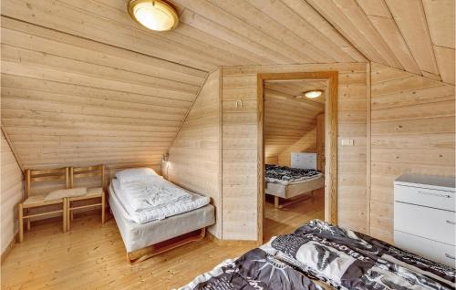 a room with two beds in a wooden cabin at Stunning Home In Tarm With Kitchen in Hemmet