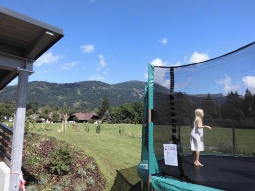 a little girl standing on a trampoline at Haus Lichtblick in Seeboden
