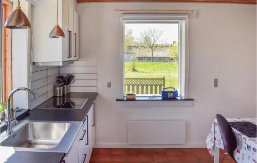 a kitchen with a sink and a window at Four-Bedroom Holiday Home In Tranekar in Tranekær