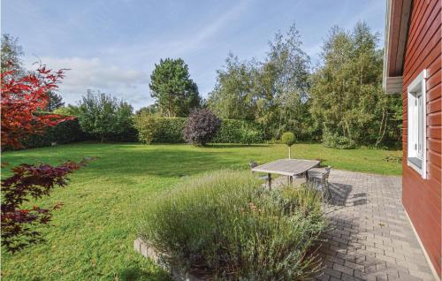 a backyard with a picnic table in the grass at One-Bedroom Holiday Home In Kalundborg in Kalundborg