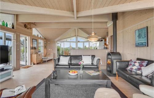 a living room with a couch and a table at Holiday Home Skovridervænget Denm in Spodsbjerg