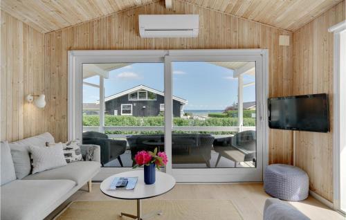 a living room with a couch and a tv at Three-Bedroom Holiday Home In Bjert in Binderup Strand