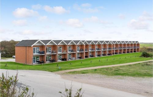 a large brick building with a road in front of it at 2 Bedroom Stunning Home In Højer in Højer