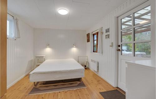 a bedroom with a bed in a white room at Awesome Home In Stege With Wifi in Stege