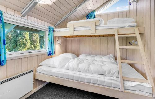 SkovbyにあるAmazing Home In Sydals With 3 Bedrooms, Sauna And Wifiの小さな家の中にある二段ベッド付きのベッドルーム1室です。