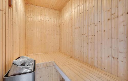 a wooden sauna with a trash can in it at Beautiful Home In Rømø With Sauna in Rømø Kirkeby