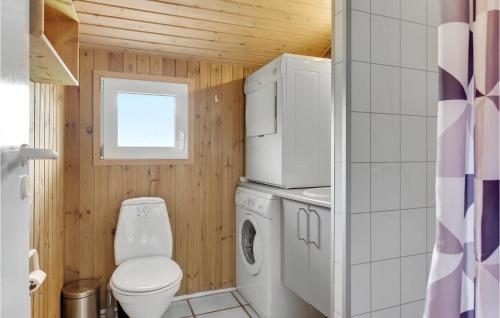 a small bathroom with a toilet and a washer and dryer at 4 Bedroom Pet Friendly Home In Sydals in Neder Lysabild