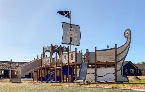 a playground with a pirate ship and a slide at Awesome Home In Sydals With Sauna in Sarup