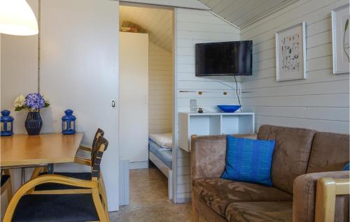 a living room with a couch and a table at 2 Bedroom Nice Home In Nexø in Neksø