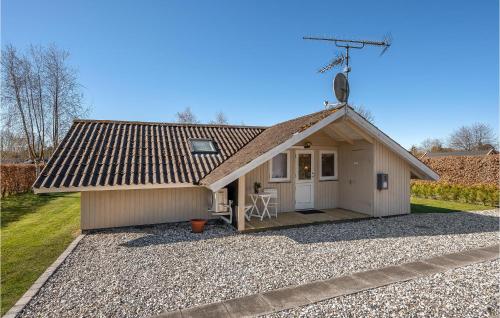 a small house with a antenna on top of it at Holiday Home Gøgevej Dronningmølle Vi in Dronningmølle